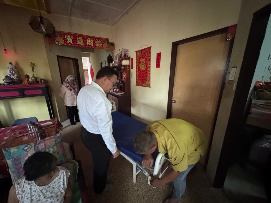 Chinese Senior Citizen in Haji Baki Receives Hospital Bed Loan from GVT